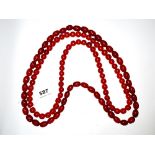 Three large reconstituted amber necklaces, largest bead size 2.5cm. Longest necklace 100cm.