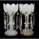 A pair of early 19th Century opaline glass lustre with cut crystal drops with one missing, H. 25cm.