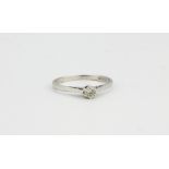 A 9ct white gold diamond set solitaire ring, (M.5).