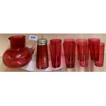 A Victorian cranberry glass water jug, sugar shaker and eight beakers.