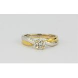 An 18ct yellow and white gold (stamped 18ct) brilliant cut diamond set solitaire ring, approx. 0.