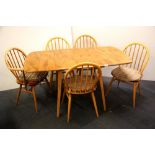 An Ercol drop leaf dining table and five chairs including one carver, length open 135cm.