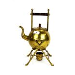 A Christopher Dresser gilt brass kettle on stand with a mahogany handle, H. 33cm.