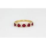 A 9ct yellow gold ruby and diamond set half eternity ring, approx. 1.8gr, (K).