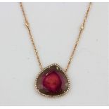 A rare watermelon tanzanite and diamond pendant set into an 18ct rose gold mount and chain, also set