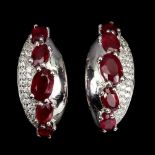 A pair of 925 silver earrings set with oval cut rubies and white stones, L. 2cm.