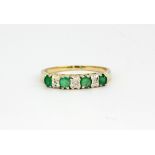 A 9ct yellow gold emerald and diamond set ring, approx. 2.5gr, (T).