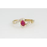 A 9ct yellow gold ruby and diamond set crossover, (M.5).