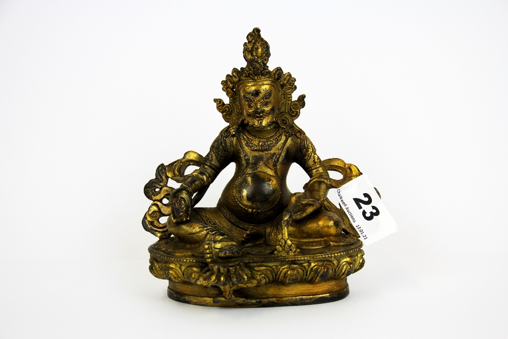 A Tibetan gilt bronze figure of a seated Deity, H. 15cm.