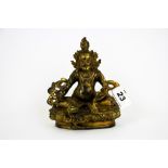 A Tibetan gilt bronze figure of a seated Deity, H. 15cm.