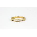 A 9ct yellow gold diamond set half eternity ring, (O).