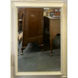 A large framed bevelled glass mirror, 80 x111cm.