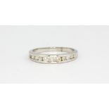 A 9ct white gold diamond set half eternity ring, (P).