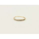 A 9ct yellow gold diamond set half eternity ring, approx. 1gr, (V).