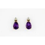 A pair of 9ct yellow gold stud earrings set with pear cut amethysts and brilliant cut diamonds, L.