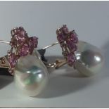 A pair of 18ct yellow gold earrings set with pink sapphires and baroque pearls.