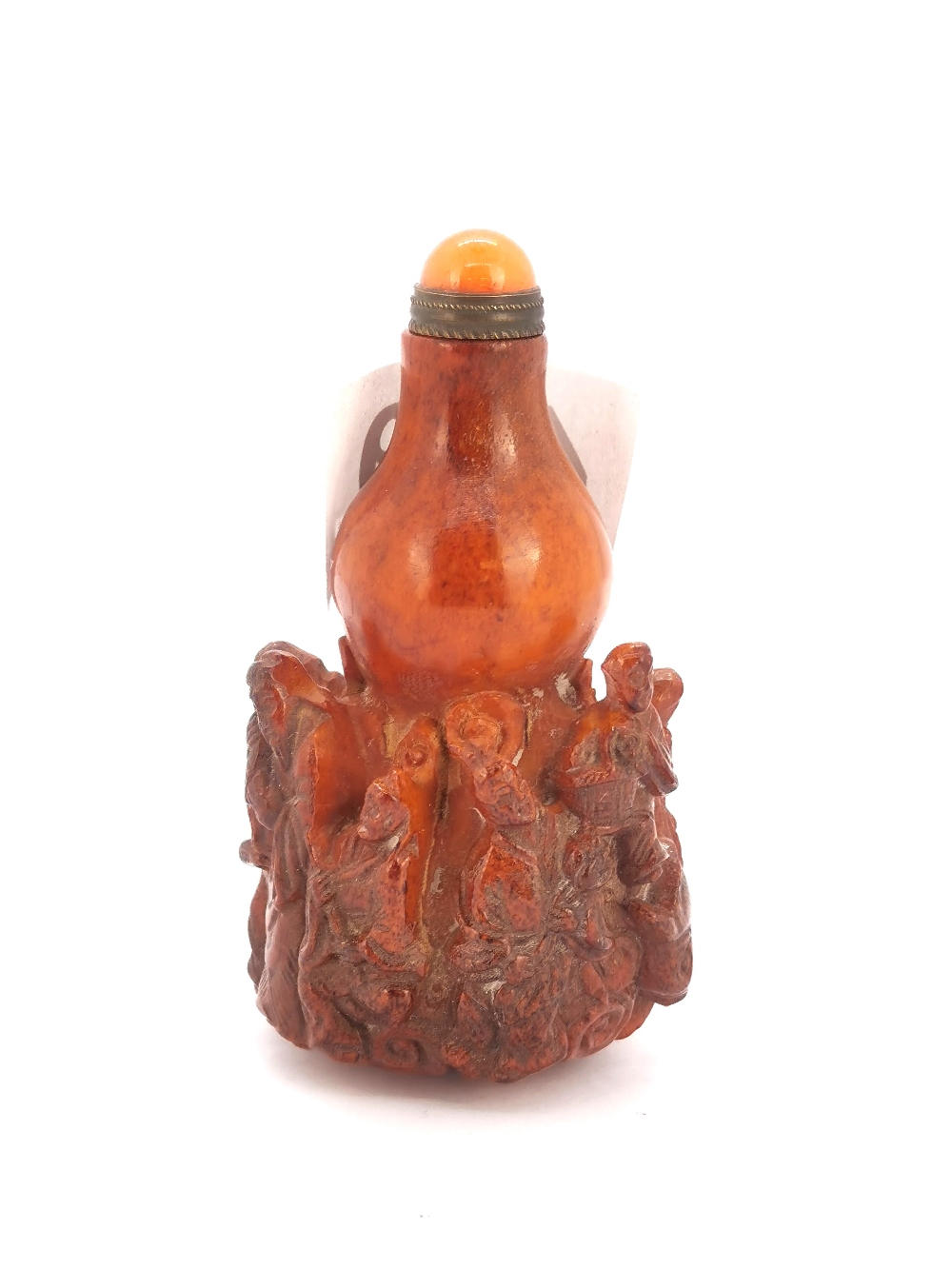 A unusual Chinese carved deer antler snuff bottle decorated with figures of immortals with a gilt