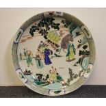 A large Chinese hand painted wucai decorated porcelain charger, Dia. 42cm. D. 7cm .