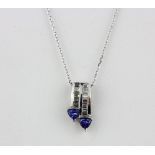 A very similar pair of 9ct white gold tanzanite and baguette diamond earrings and pendant on a 9ct