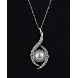 An 18ct white gold South Sea pearl and diamond set pendant on a 9ct gold chain, L. 3.5cm.