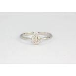 A 9ct white gold diamond set cluster ring, (P.5).