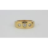 A heavy gent's 9ct yellow gold (import hallmarked) three stone diamond ring. Stamped for 0.75ct. (