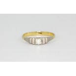 An 18ct yellow and white gold brilliant cut diamond set solitaire ring, (S).