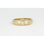 A 9ct yellow gold ring set with princess cut white stones, approx. 2.1gr, (N).