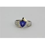 A matching 18ct white gold (stamped 18k) tanzanite and baguette cut diamond ring. (P).