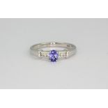 A 9ct white gold tanzanite and diamond set ring, (N.5).