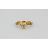 An 18ct rose gold solitaire ring set with a 1ct brilliant cut diamond and diamond set shoulders, (