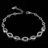 A 925 silver bracelet set with oval cut apatites and white stones, L. 7cm.