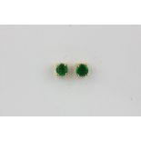 A pair of 14ct white gold (stamped 585) emerald set stud earrings.