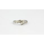 An 18ct white gold diamond set crossover ring, approx. 0.25ct, (N.5).