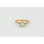 An 18ct yellow gold and platinum diamond set solitaire ring, approx. 0.25ct overall, (O).