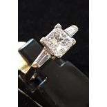 An 18ct white gold solitaire ring set with a princess cut approx. 1.4ct diamond, with tapered