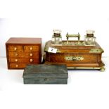 A Victorian brass mounted oak desk stand with cut glass bottles, together with a French travelling