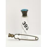 An enamelled silver topped smelling salts bottle, 7.5cm. and a Scottish silver kilt pin.