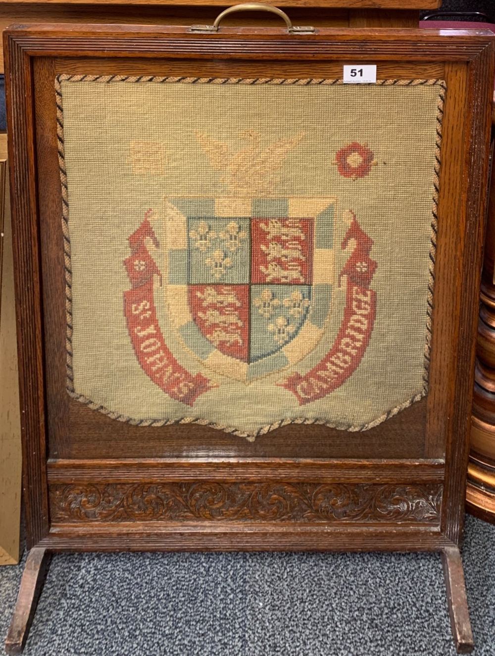 A 1920's oak fire screen inset with a tapestry panel for St. John's College in Cambridge, H. 77cm.