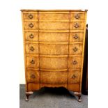 A lovely 1920's burr walnut veneered serpentine fronted six drawer chest, H. 133cm.