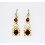 A pair of yellow metal (tested minimum 9ct gold) garnet set drop earrings and matching pendant, L.