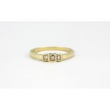 A 9ct yellow gold ring set with three princess cut diamonds, approx. 2.1gr, (P).