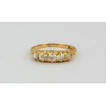 An 18ct yellow gold (stamped 18ct) ring set with five old cut diamonds, (N.5).