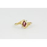 A 9ct yellow gold ruby and diamond set ring, (K.5).