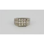 A gent's hallmarked 18ct white gold nine diamond ring, approx 0.75ct. (T).