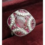 An Art Deco style 18ct white gold ring set with rubies and diamonds, (M).