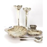 An ornate hallmarked silver shell bowl, a hammered silver dish, two bud vase and three other items.