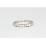 An 18ct white gold diamond set half eternity ring, approx. 2.7gr, (P).