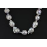 A single strand necklace of large grey baroque pearls, average size 16mm. L. 41cm. Together with a