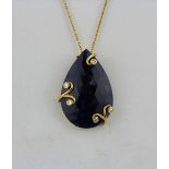 An impressive large natural pear cut sapphire pendant, approx 30ct, set in 18ct yellow gold with